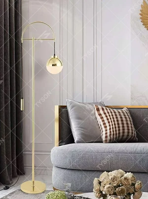Light luxury golden curved metal floor lamp, spherical gold-frame white shade + round base, soft lighting, creating a high-end elegant atmosphere.