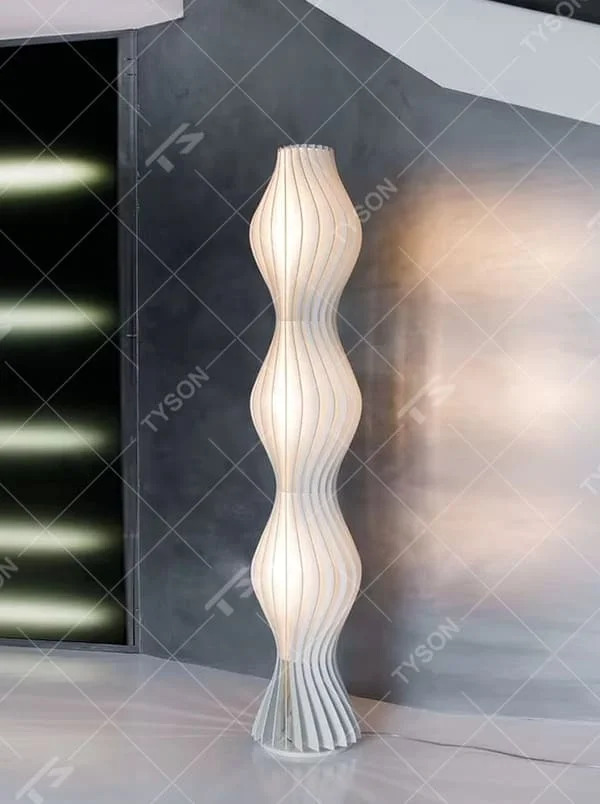 Modern artistic wave-shaped striped floor lamp, light-colored panels spliced into a curved shape, soft and hazy lighting, creating an artistic minimalist atmosphere.