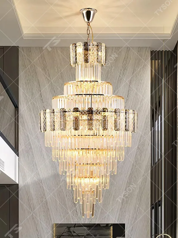Luxurious multi-layer crystal tower chandelier, golden frame paired with transparent crystals and textured decorative blocks, brilliant and gorgeous lighting, creating a high-end luxurious atmosphere.