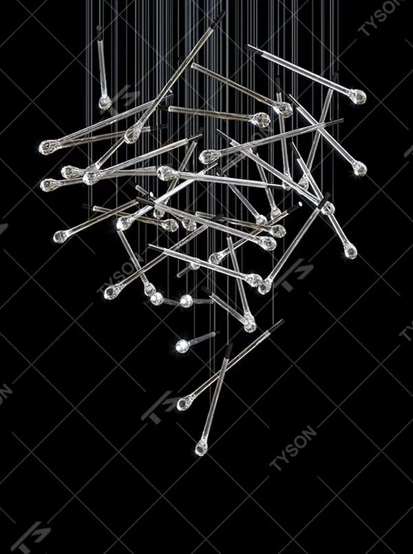 This is a modern artistic transparent crystal rod staggered hanging chandelier, with silver metal slender rods paired with crystal ends, multiple rods staggered and hung. When the lights are on, it is brilliant and dreamy, creating a highly artistic space atmosphere.