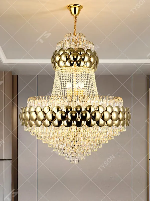 This is a luxurious multi-layer golden ball crystal chandelier, featuring a multi-layer structure combining golden metal balls and crystals. When lit, the light is brilliant and gorgeous, creating a high-end luxurious space atmosphere.