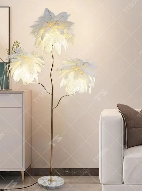 This is a light luxury soft feather-shaped floor lamp, equipped with three white feather lampshades, paired with a golden curved lamp pole and a marble base. The design is gentle and elegant, with soft and hazy lighting through the feathers. It is used for space lighting and decoration, creating a warm and soft light luxury atmosphere. Suitable for light luxury-style living rooms, bedrooms, internet-famous homestays and other places.