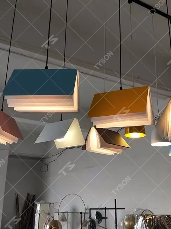 Creative origami book-shaped colorful hanging chandelier, folded structure + multi-color appearance (orange/pink/white/blue, etc.), soft and warm lighting, creating a literary creative atmosphere.