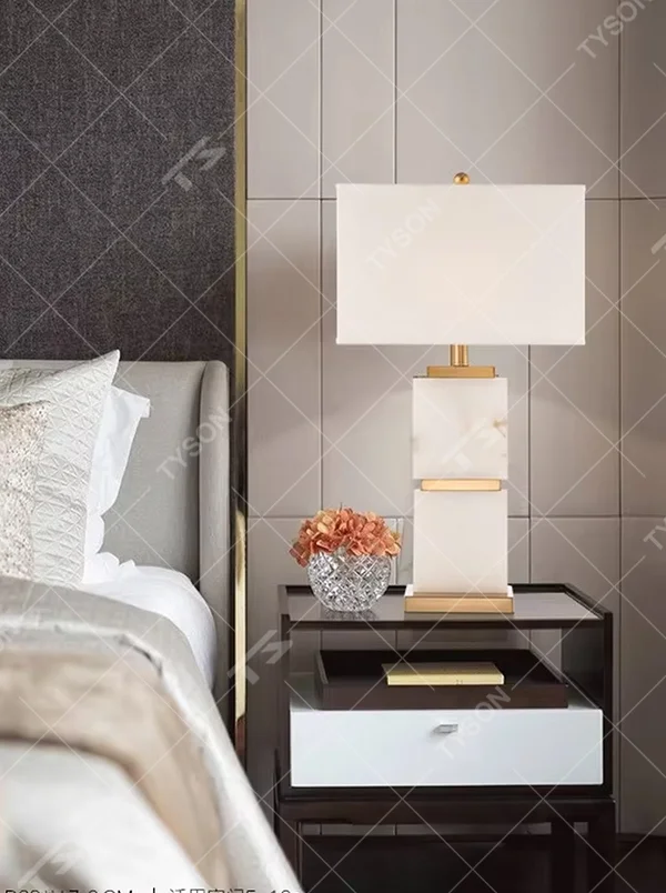 Light luxury white veined stone gold-decor rectangular fabric lampshade table lamp, white veined stone main body + golden metal decoration + white fabric lampshade, soft light, creating a high-end light luxury atmosphere.