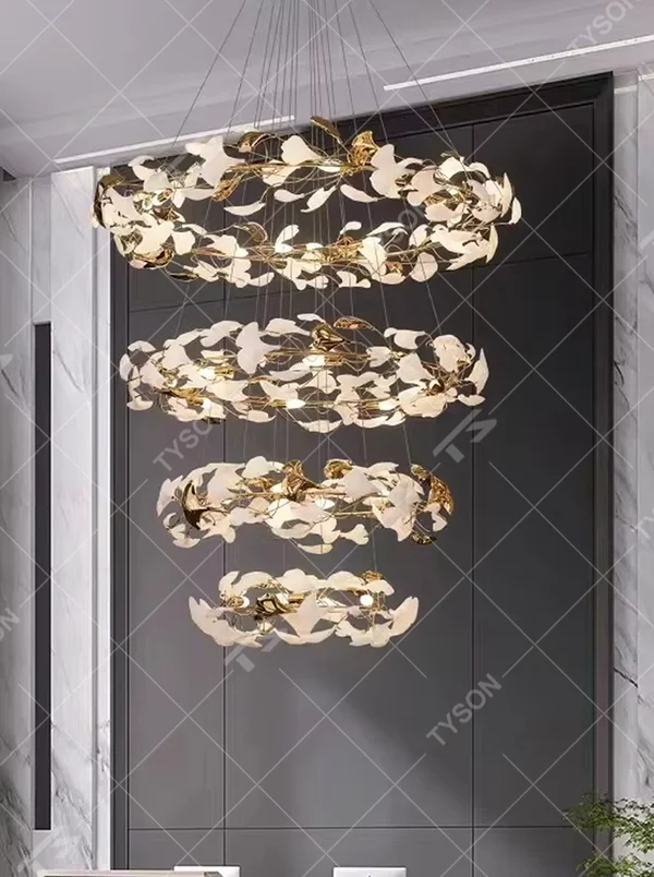 Light luxury art ginkgo leaf-shaped multi-layer hanging chandelier, golden metal curved frame + white ginkgo leaf decorative light panels, soft and elegant lighting, creating a high-end artistic atmosphere.