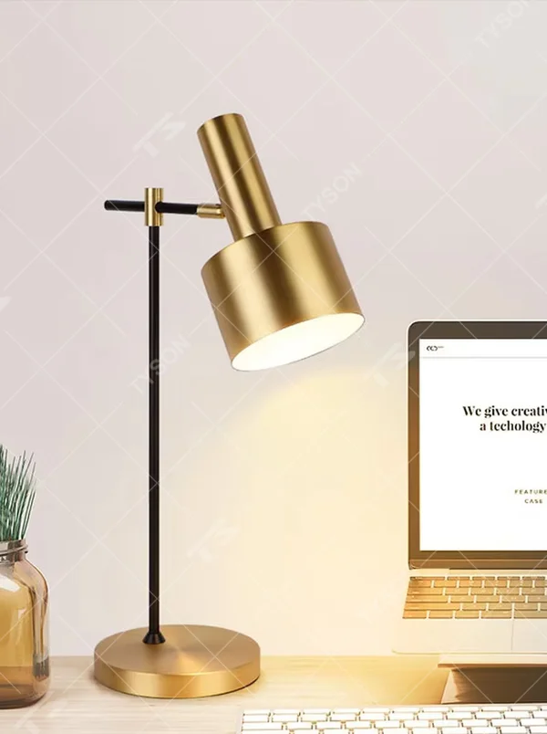 Modern light luxury black-gold adjustable metal table lamp, golden lampshade + black-gold stand + round golden base, angle-adjustable, soft warm light, creating a simple high-end office/home atmosphere.