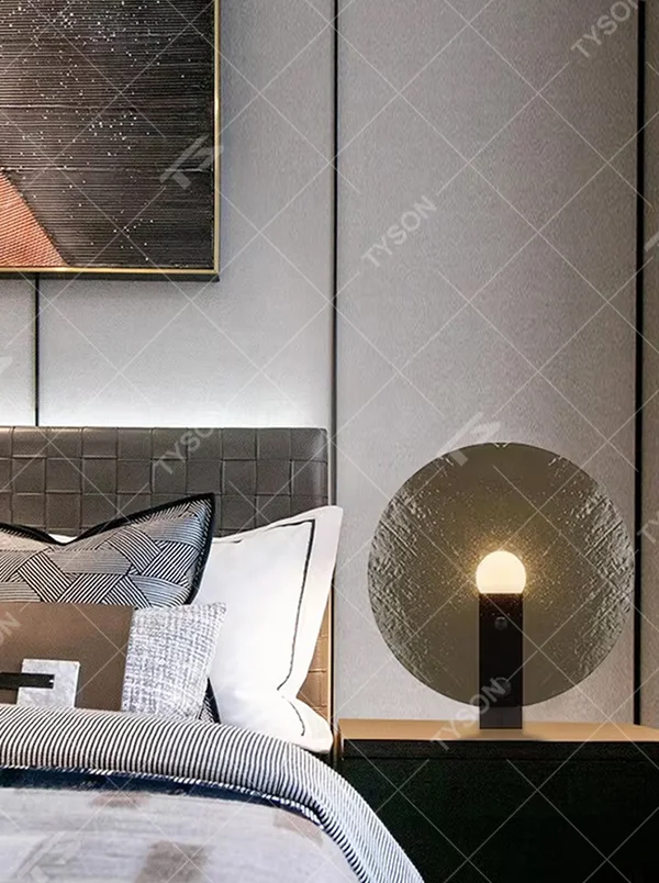 Modern artistic circular texture decorative table lamp, black base + spherical soft light shade, soft and warm lighting, creating a high-end minimalist atmosphere.