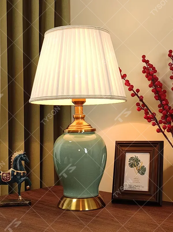 Vintage elegant-style beige pleated fabric lampshade table lamp, white porcelain vase base + golden metal decorations, soft and warm lighting, creating an elegant and cozy atmosphere.