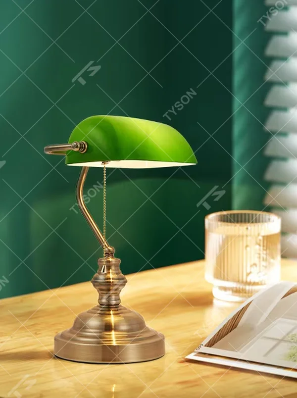 Vintage industrial-style green shade brass adjustable table lamp, semi-circular green shade + brass metal stand + pull chain switch, soft warm light creates vintage atmosphere.