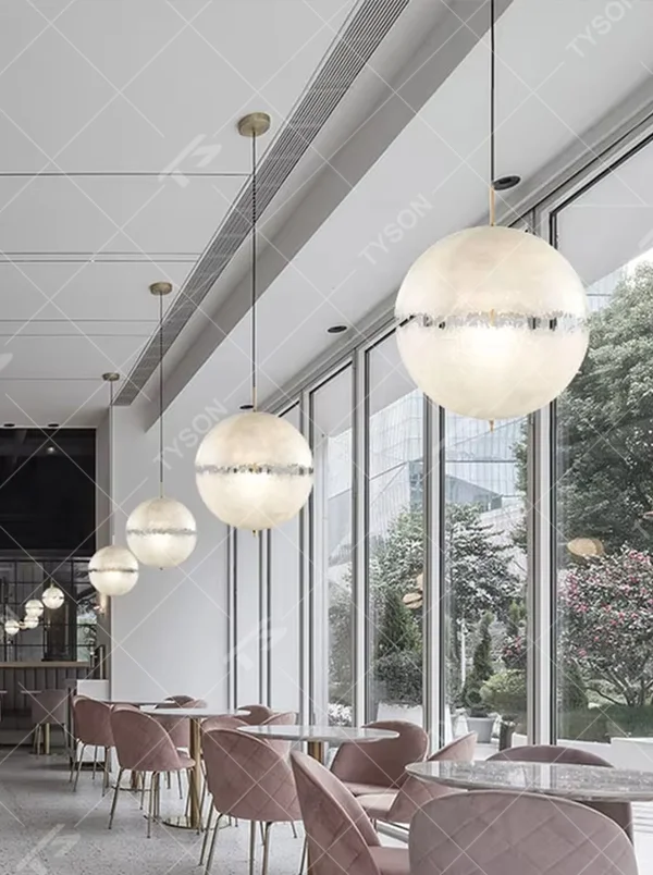 Modern art-style multi-head frosted spherical chandelier, water-textured white shade + black-gold decoration + warm light effect, creating a fresh artistic atmosphere in public spaces.
