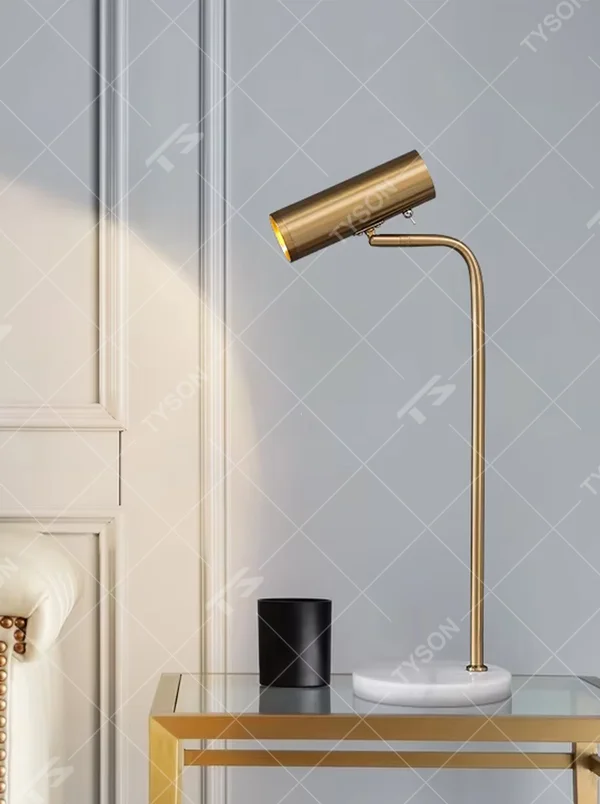 Modern light luxury golden metal curved-arm cylinder head table lamp, white marble base + warm light effect, creating an exquisite minimalist home atmosphere.