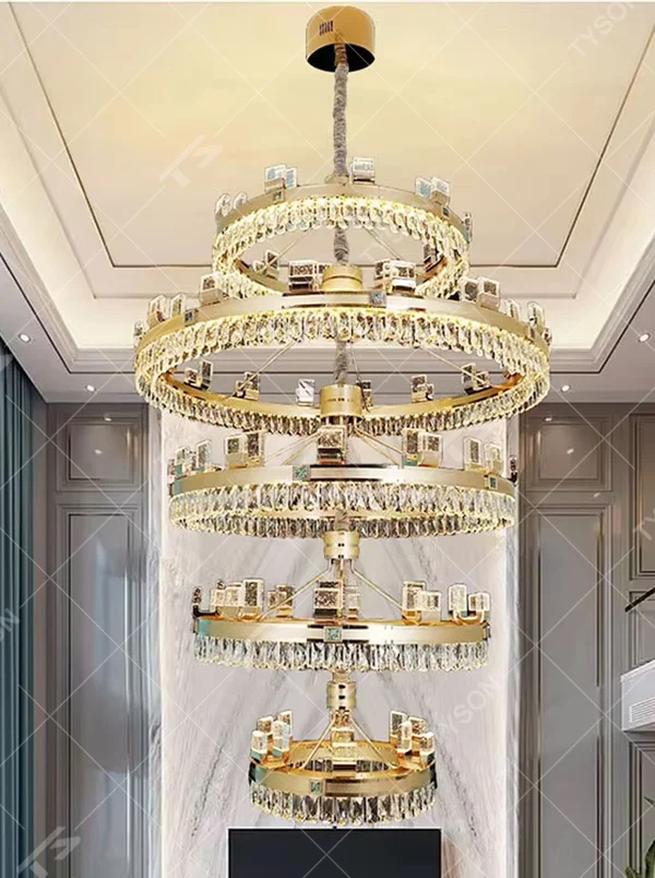 Top-luxury modern multi-layer ring crystal chandelier, golden frame + full crystal inlay + square decorations, brilliant warm light creates luxurious atmosphere in high-ceiling spaces.