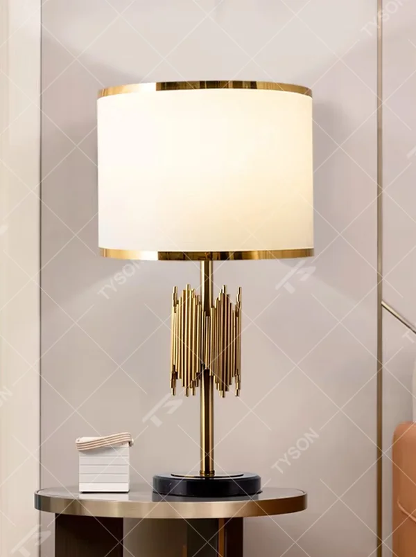 Modern light luxury black-gold striped decorative table lamp, golden metal striped base + white shade with gold trim + warm light effect, creating an exquisite luxurious home atmosphere.