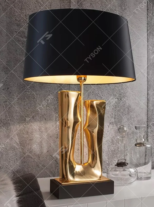 Modern art luxury black-gold sculpture base table lamp, golden streamlined sculpture base + black shade with gold lining + warm light effect, creating a high-end artistic luxury atmosphere.