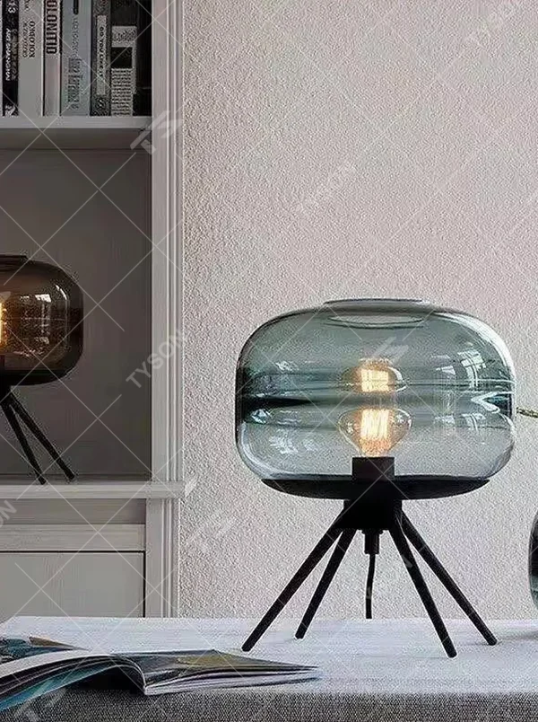 Light luxury dark green glass ball table lamp (dark green double-layer glass ball + black triangular stand), warm light effect, creating a fresh and high-end home atmosphere.