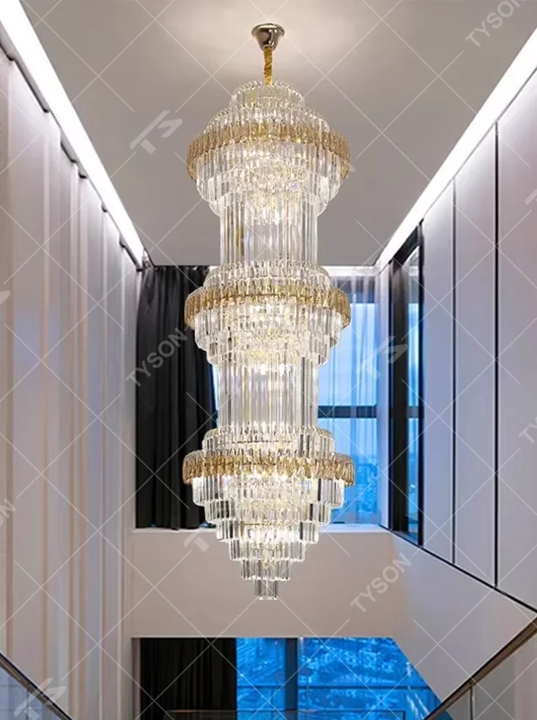 Modern top-luxury multi-layer crystal tower-shaped high-ceiling chandelier (gold-gray frame + long crystals), warm light effect, creating a luxurious and grand space atmosphere.