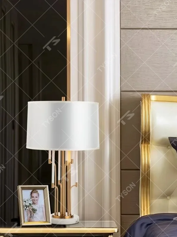 Luxury multi-pole metal table lamp (gold pole + white shade + marble base), warm light effect, creating an elegant and high-end light luxury space atmosphere.