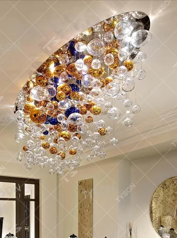 Art colorful glass ball suspension chandelier (gold/blue/transparent combination), warm light effect, creating a dreamy and brilliant luxurious space atmosphere.