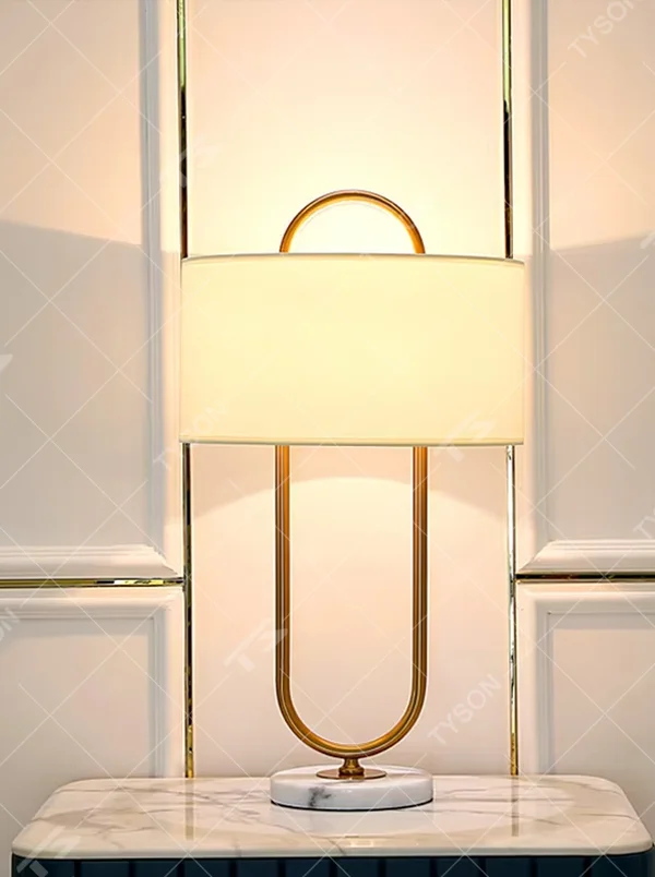 Light luxury U-shaped gold frame table lamp (gold U-shaped stand + fabric shade + marble base), warm light effect, creating an elegant and high-end home atmosphere.