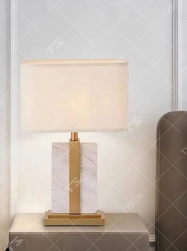 Light luxury color-blocking square base table lamp (black-gold color-blocking base + linen shade), warm light effect, creating a simple and high-end home atmosphere.