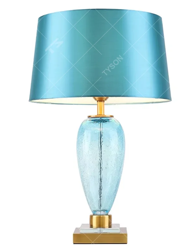 Light luxury lake blue glass bottle-shaped table lamp (satin fabric shade + gold trim), warm light effect, creating a fresh and elegant space atmosphere.
