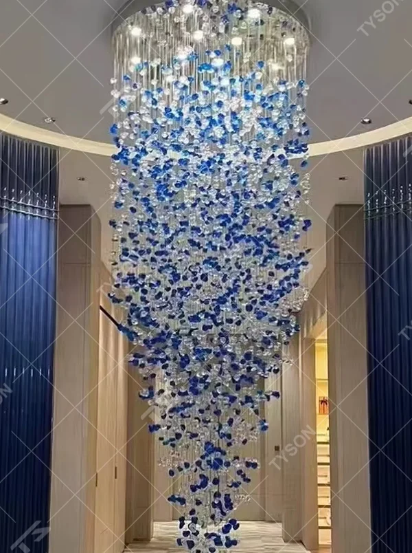 Luxury blue-white crystal column chandelier (gradient color crystals + hanging shape), warm light effect, creating a brilliant and elegant high-end space atmosphere.