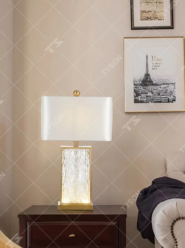 Light luxury golden frame ice-textured glass square table lamp (satin white shade), warm light effect, creating an exquisite and high-end space atmosphere.