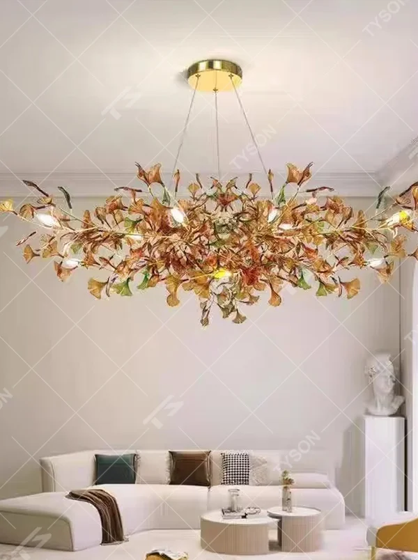 Art Ginkgo Leaf Light Luxury Chandelier (orange-yellow gradient glass leaves + gold metal frame), warm light effect, creating a natural and elegant atmosphere in large flat-floor living rooms.