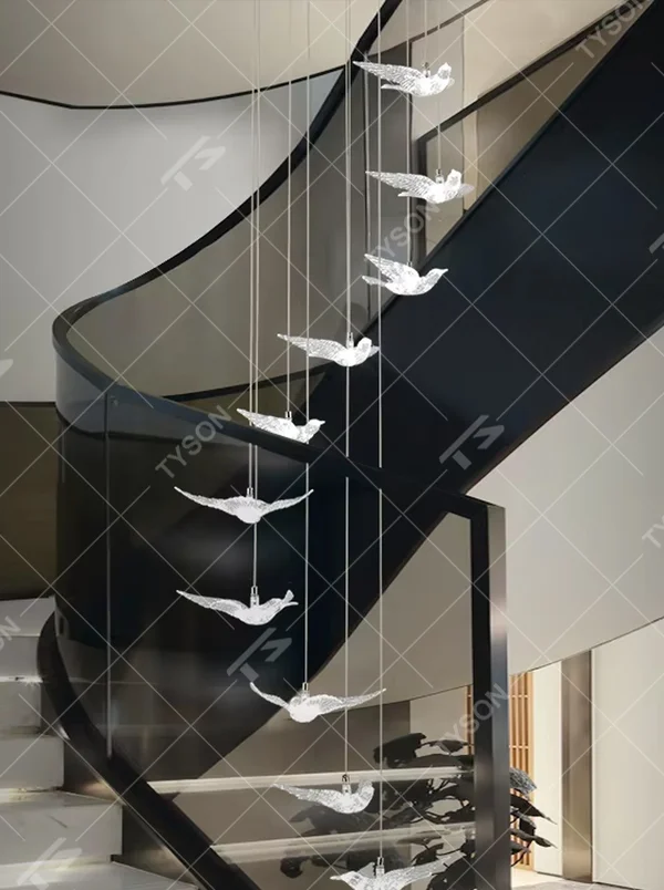 This art chandelier features bird shapes made of light-transmitting material, hung staggered with slender suspension rods, creating a vivid effect of a flock of birds flying, serving both lighting and decorative purposes, ideal for high-ceiling commercial spaces such as sales offices, hotel lobbies, and art exhibition halls.