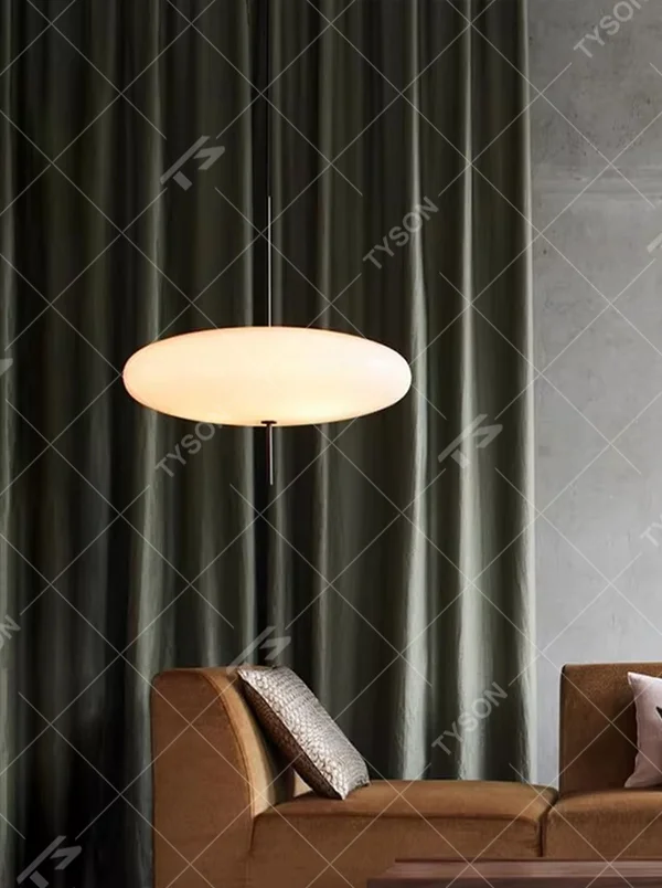 This modern minimalist flat round chandelier features a milky white frosted acrylic lampshade, paired with a thin black suspension rod, transmitting light softly. It serves both lighting and decorative purposes, ideal for modern minimalist spaces such as living rooms, bedrooms, and light luxury restaurants.