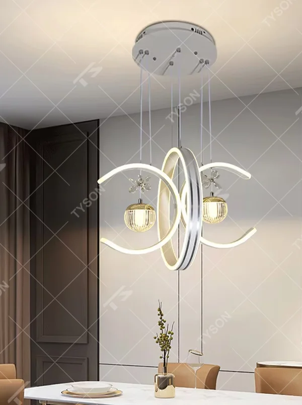 This modern light luxury chandelier features interlaced ring-shaped LED bodies and spherical crystal lamp shades with dragonfly decorations. It has smooth, layered lines, serves both lighting and decorative purposes, and is ideal for modern home spaces like dining rooms and living rooms, as well as light luxury commercial venues.