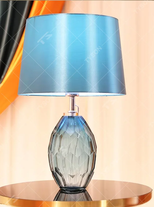 This light luxury modern table lamp features a blue-gray cut-textured glass lamp body, paired with a sky-blue fabric conical lampshade, with exquisite metal connectors. It serves both lighting and decorative purposes, ideal for light luxury spaces such as bedroom bedside tables, living room side tables, and hotel guest rooms.