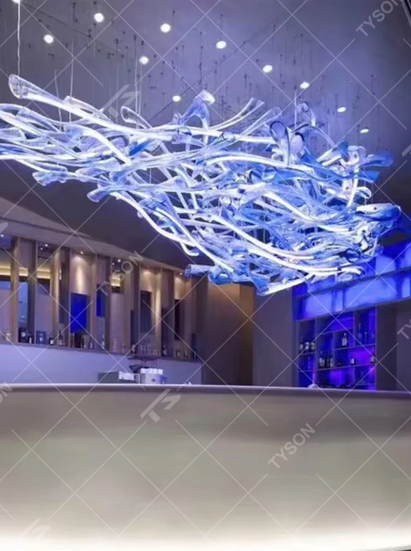 This large-scale art glass chandelier features a streamlined nebula/wave shape made of blue-white gradient transparent glass strips, hung in a suspended manner. It serves both lighting and artistic decorative purposes, ideal for high-ceiling commercial spaces such as hotel lobbies, high-end bars, and sales offices.