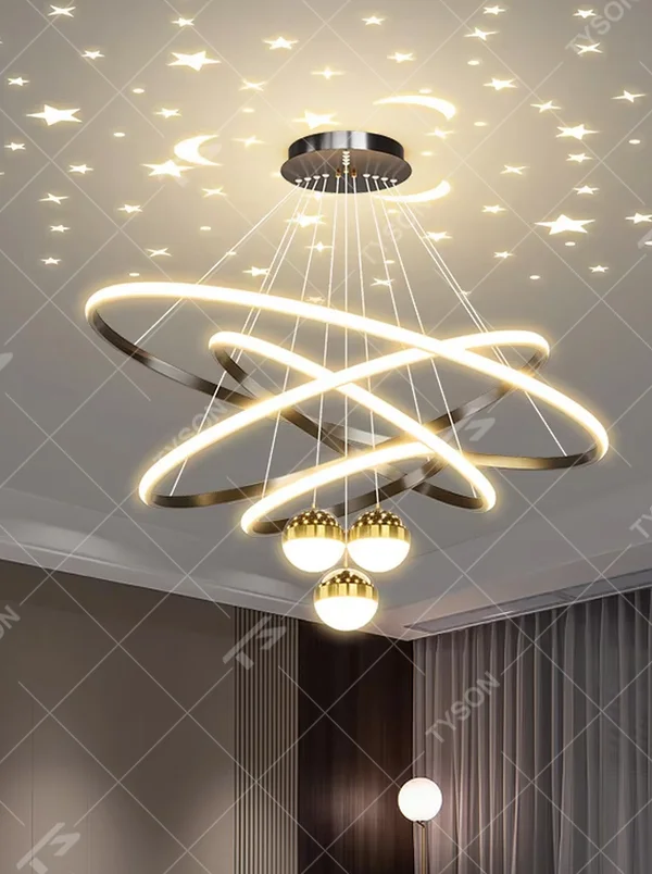 This modern light luxury galaxy-shaped chandelier features multi-layer interlaced ring light strips made of black and gold metal, paired with spherical crystal lamp shades, and has a built-in star and moon projection effect on the top. It serves both lighting and decorative purposes, ideal for modern home spaces such as living rooms and dining rooms, as well as light luxury commercial venues.