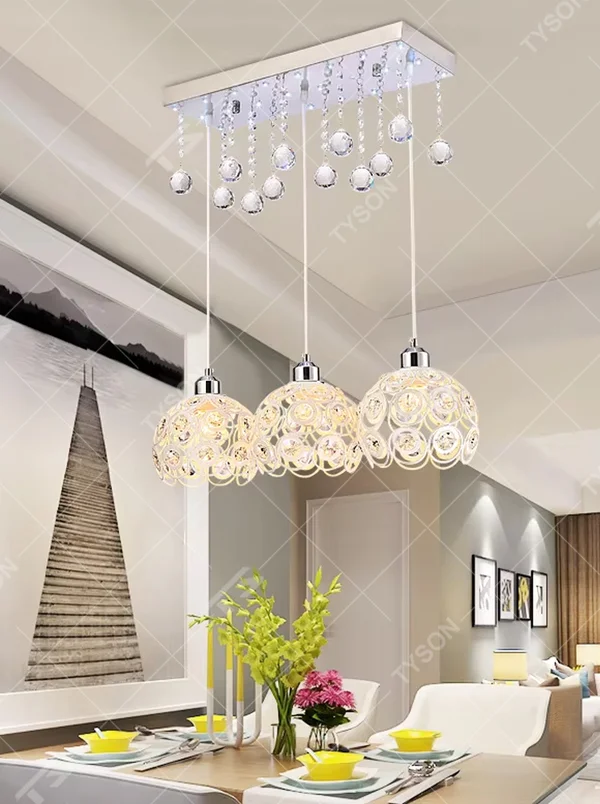 This light luxury three-head dining chandelier features a black metal top frame, paired with silver suspension rods and hollow black-gold spherical lampshades (embedded with crystal accents), with an exquisite and brilliant shape, serving both lighting and decorative purposes, ideal for dining rooms, bars, light luxury homes and other scenarios.