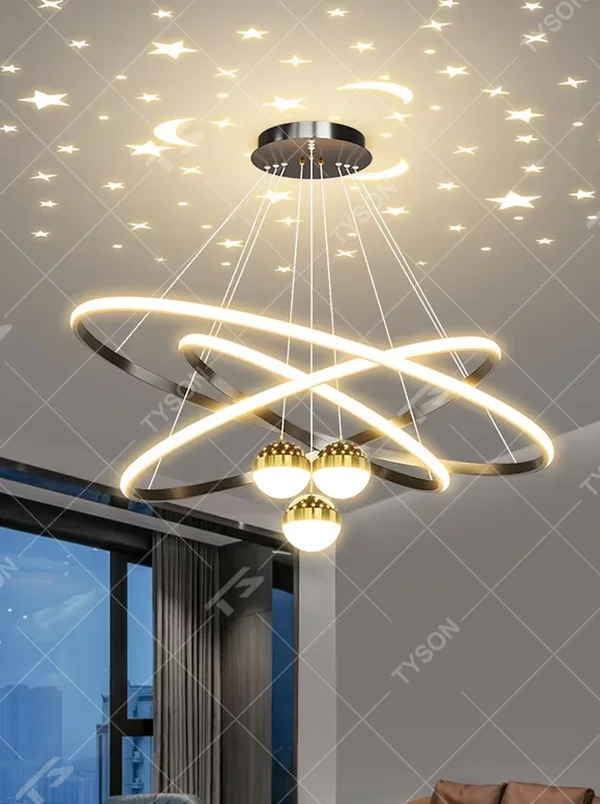 This modern light luxury galaxy-shaped chandelier features multi-layer interlaced ring light strips made of gold metal, paired with spherical crystal lamp shades, and has a built-in starry sky projection effect on the top. It serves both lighting and decorative purposes, ideal for modern home spaces such as living rooms and dining rooms, as well as light luxury commercial venues.