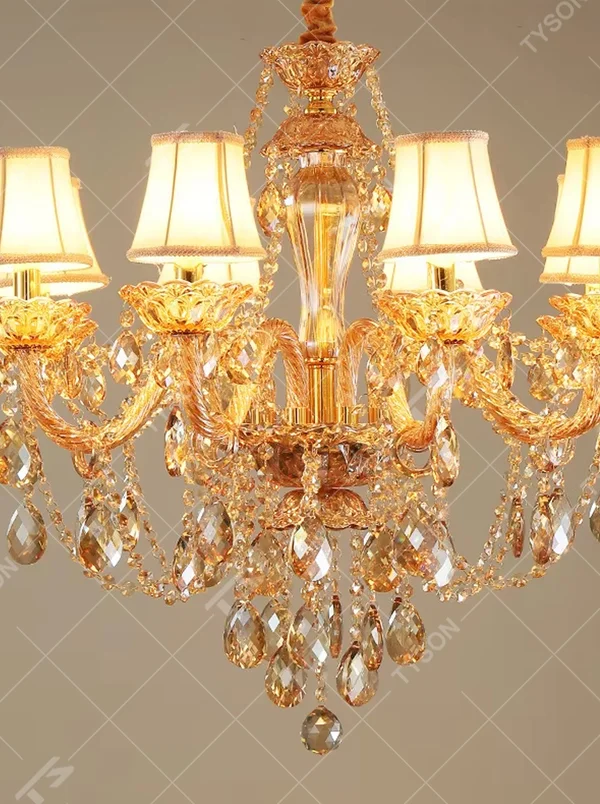 European-style luxury golden crystal chandelier, with amber multi-layer crystal pendants, off-white fabric lampshades and gold carved metal frames, providing warm and brilliant light, designed to enhance the luxurious atmosphere of spaces, suitable for high-end scenarios such as villa living rooms, hotel lobbies, and banquet halls