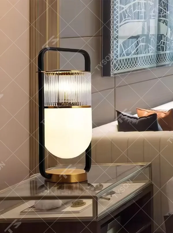 This modern light luxury lantern-shaped table lamp features a black-gold metal frame (with a handle design), paired with a double-layer lampshade of vertical-grain transparent glass and milk-white frosted glass, with an exquisite gold base. It serves both lighting and decorative purposes, ideal for light luxury spaces such as bedroom bedside tables, living room side tables, and hotel guest rooms.