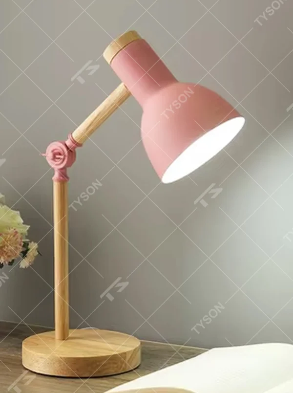 This Nordic-style eye-caring table lamp features a solid wood arm and base, paired with a pink metal conical lampshade, with a rose-shaped decorative joint that supports multi-angle adjustment, serving both lighting and decorative purposes, ideal for studies, children's rooms, bedrooms and other spaces.