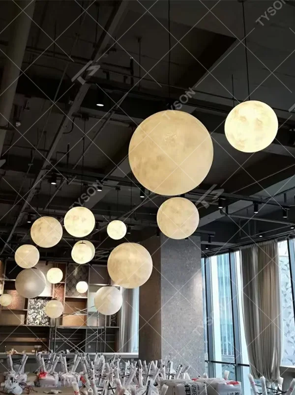 This moon-shaped chandelier simulates lunar surface texture with soft light-transmitting material, hung in varying sizes, serving both lighting and decorative purposes, ideal for Internet celebrity restaurants, cafes, office spaces, exhibition halls and other scenarios.