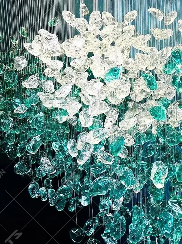 This large dome crystal chandelier features a teardrop-shaped pendant design made of blue-white gradient crystal clusters, like blooming flower clusters or deep-sea ripples, serving both lighting and artistic decoration purposes, ideal for high-ceiling commercial spaces such as hotel lobbies, sales offices, and high-end clubs.