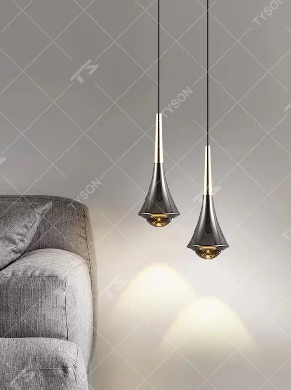 This minimalist light luxury conical small chandelier features a water-drop shape made of black-gold metal, with a thin gold rod on top, projecting soft light spots, serving both lighting and decorative purposes, ideal for bedroom bedside tables, dining bars, light luxury commercial spaces and other scenarios.