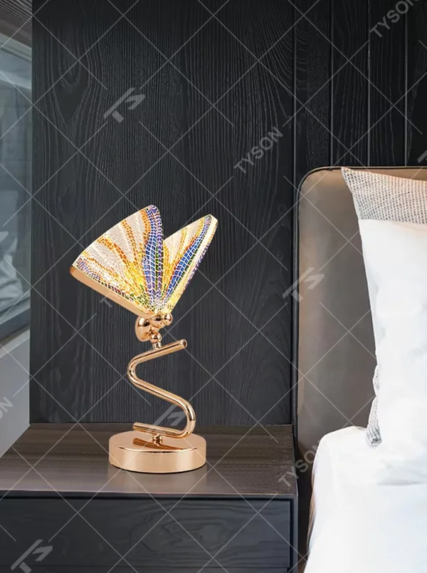 This light luxury modern table lamp features a gold S-shaped metal stand, paired with a ginkgo leaf-shaped textured translucent lampshade, supports angle adjustment, serves both lighting and decorative purposes, ideal for light luxury spaces such as bedroom bedside tables, living room side tables, and hotel guest rooms.
