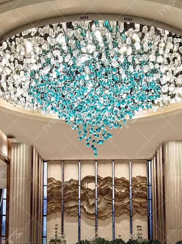 This large-scale art crystal chandelier features a dome pendant shape made of blue-white gradient crystal clusters, like blooming flower clusters or deep-sea ripples. It serves both lighting and artistic decorative purposes, ideal for high-ceiling commercial spaces such as hotel lobbies, sales offices, and high-end clubs.