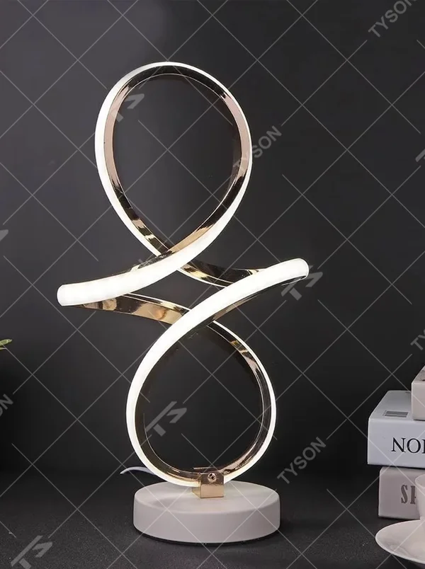 This light luxury art table lamp features a "8"/infinity symbol shape made of gold metal, with embedded LED light strips and a white marble base, serving both lighting and decorative purposes, ideal for living room side tables, bedroom bedside tables, light luxury homestays and other spaces.