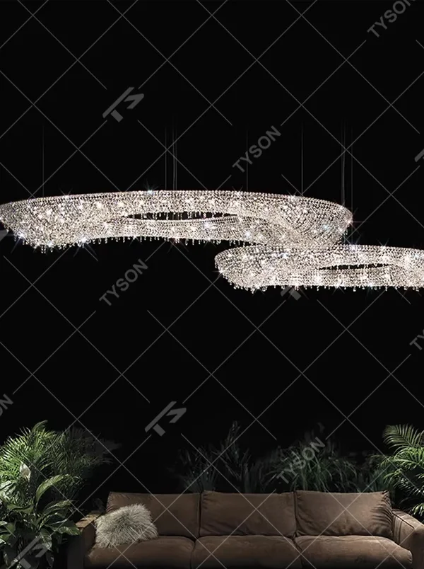 Modern art double-ring streamlined crystal chandelier, with dense crystal particles forming a flowing cloud pattern with staggered double rings, emitting brilliant and transparent light, combining artistic decorativeness and lighting function, suitable for core lighting and atmosphere creation in large spaces such as high-ceiling living rooms, villa hollow areas, and high-end clubs.