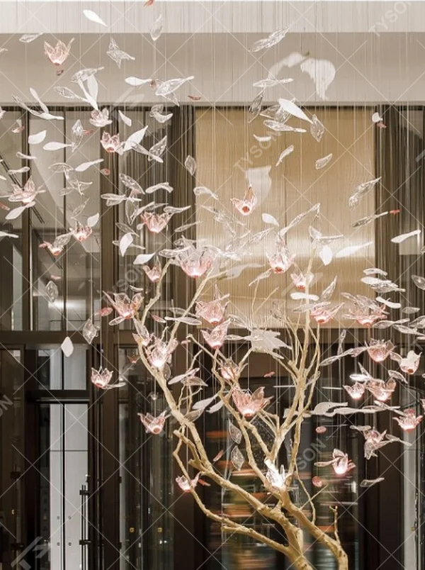 This is an art-installation style tree-shaped chandelier, with a simulated branch as the main structure, paired with transparent and pink-white gradient leaf-shaped luminous components, which has both artistic decoration and soft lighting functions, suitable for large commercial spaces such as hotel lobbies, high-end clubs, and art exhibition halls.