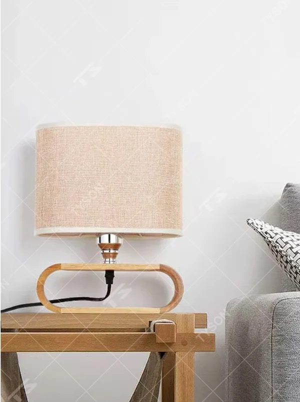This is a Nordic minimalist style wooden table lamp, featuring a curved solid wood stand paired with a linen fabric lampshade. It emits soft and warm light, serving both lighting and decorative purposes, suitable for bedroom nightstands, living room side tables, studies, homestay guest rooms and other scenarios.