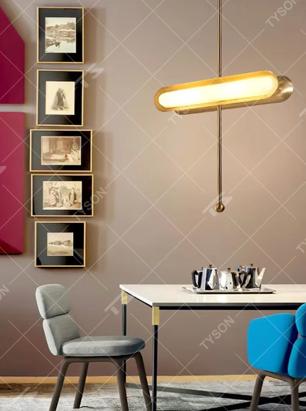 This is a modern light luxury cross-shaped artistic pendant light, featuring a bronze metal frame paired with an oval soft light-emitting lamp body, with simple and balanced lines, serving both lighting and decorative purposes, suitable for entrances, bedroom headboards, light luxury bars, minimalist living rooms and other scenarios.