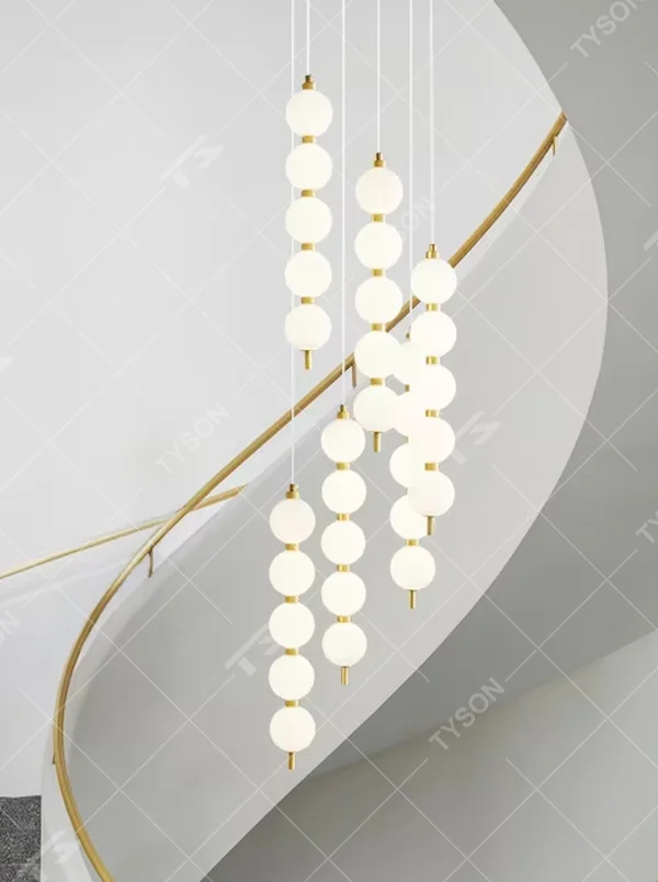 Modern light luxury style staggered spherical chandelier, composed of multiple groups of milky white glass ball lamp heads and gold metal suspension rods, arranged in a streamlined hanging layout. It emits soft and even light, combining artistic decorativeness and lighting function, suitable for core lighting and atmosphere creation in high-ceiling spaces such as duplex stairs, high-ceiling living rooms, and villa hollow areas.